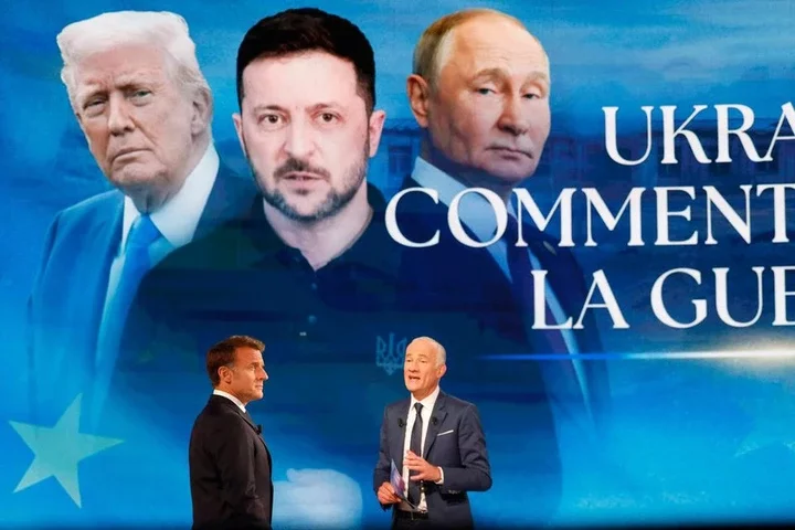 French president Emmanuel Macron (left) being interviewed by journalist Gilles Bouleau, on French TV channel TF1 on May 13.