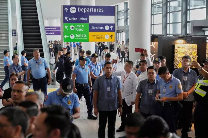 Officers patrol the airport after former President Rodrigo Duterte landed in Manila, Philippines, on March 11, 2025.