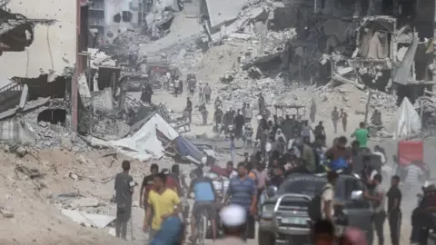 Getty Images Palestinians return to their homes after the withdrawal of Israeli army from the eastern Khan Yunis, Gaza on July 30, 2024. 