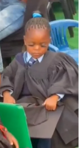 Little girl turns up for her graduation ceremony in lashes and fixed nails (video)