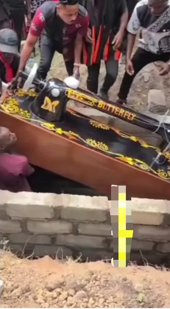 'E wan dey sew garment for heaven?' - Netizens react as Tailor is buried inside sewing machine shaped coffin (Video)