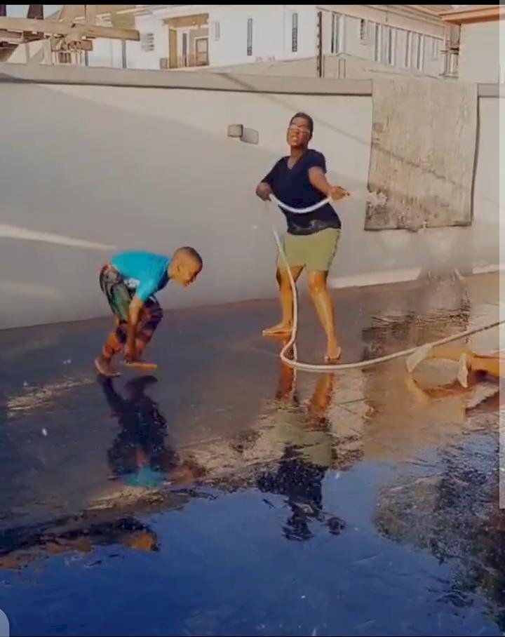 Mercy Johnson use a water hose as a gun in a fun shooting session with her kids (Video)