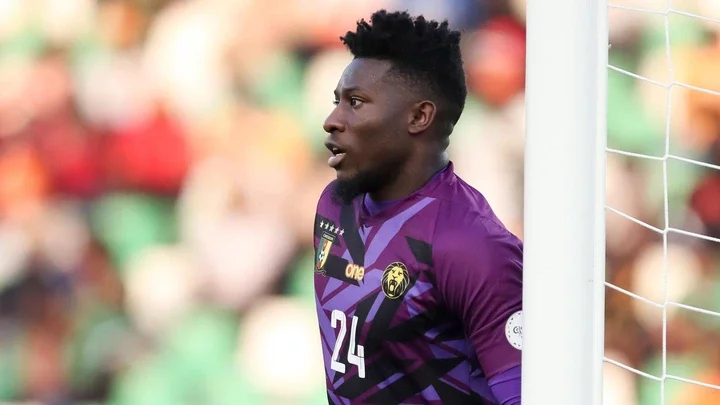 Andre Onana, wearing a purple Cameroon shirt, stands by a post while keeping goal during a football match