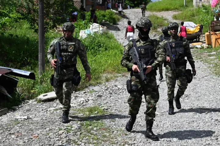 Members of the Colombian Navy patrol a street at the Nuevo Amanecer neighbourhood after a surge of cartel activity