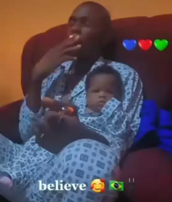 Outrage as man is seen puffing smoke while carrying months-old baby (Video)