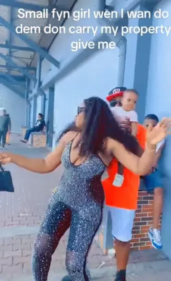 Wife causes buzz as she tries to form slay queen in public, husband quickly hands her their baby, she reacts
