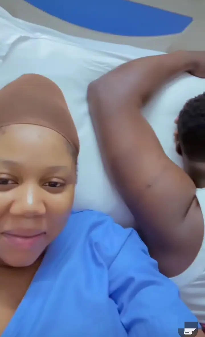 'He's resting from 9 months stress' - Man dozes on wife's maternity bed after she gave birth to their child, video stirs reactions