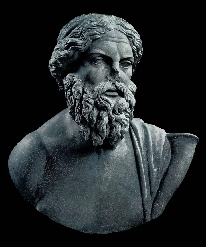 A stone bust of a man with a beard and mustache