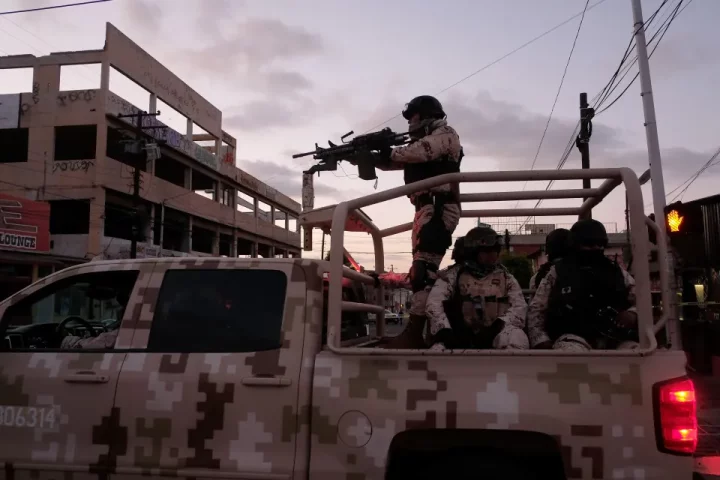 Mexican Soldiers leave the scene of a crime where a man was killed by gang gunfire in downtown Tijuana