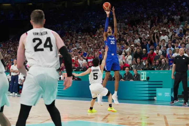 Japan's Yuki Kawamura defends against Victor Wembanyama of France during the Paris 2024 Olympic basketball tournament on July 30, 2024.