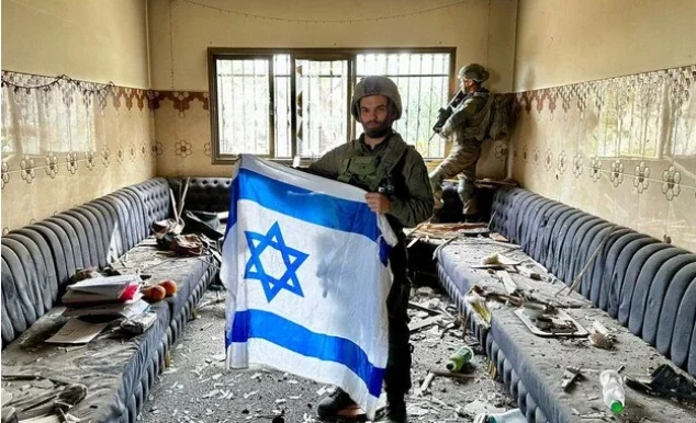 IDF soldiers pose inside his house as the net closes in on the terror warlord