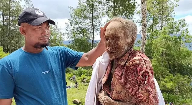 Villagers were seen posing with their dead ancestors, who had dry, paper-like skin after spending years in the ground