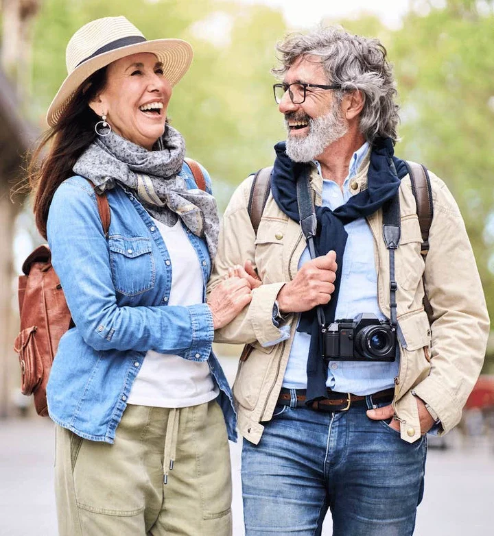 Couple walk arm in arm and chat