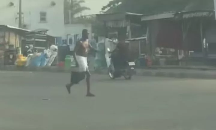 Outrage as man bathes in the middle of public road