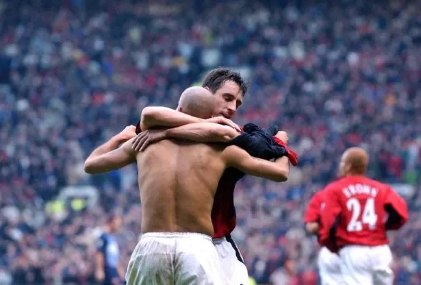 Gary Neville celebrates with Veron after his goal against Arsenal at Old Trafford in December 2002.