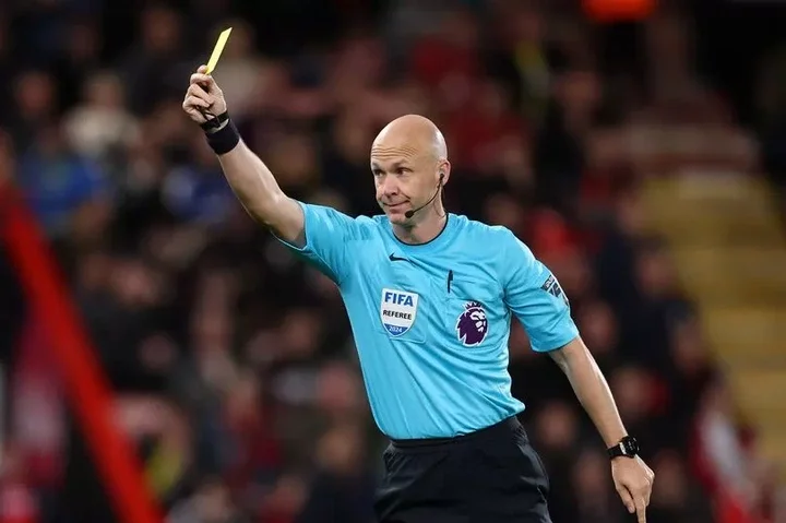 Referee Anthony Taylor shows a yellow card during the Premier League match between Bournemouth and Chelsea