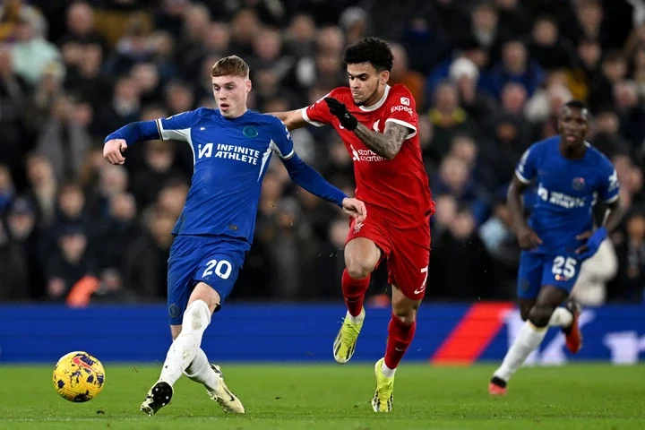 Cole Palmer of Chelsea makes a pass whilst under pressure from Luis Diaz of Liverpool during the Premier League match between Liverpool FC and Chel...