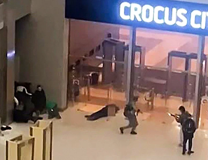 Unidentified gunmen moving towards the doors of the Crocus City Hall in Moscow