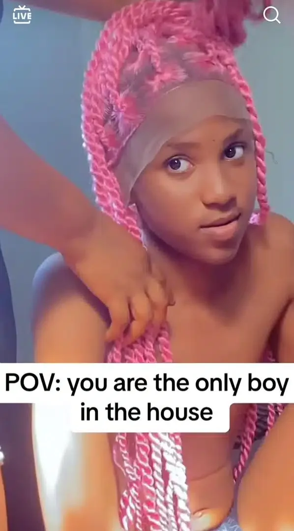 'He fine pass many girls' - Lady causes a buzz as she tries wig on her brother