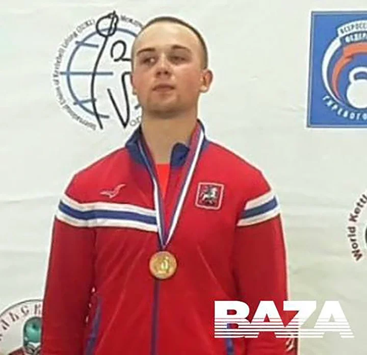 Vladimir Feshchenko, a Russian FSB counterintelligence officer, wearing a red jacket and gold medal.