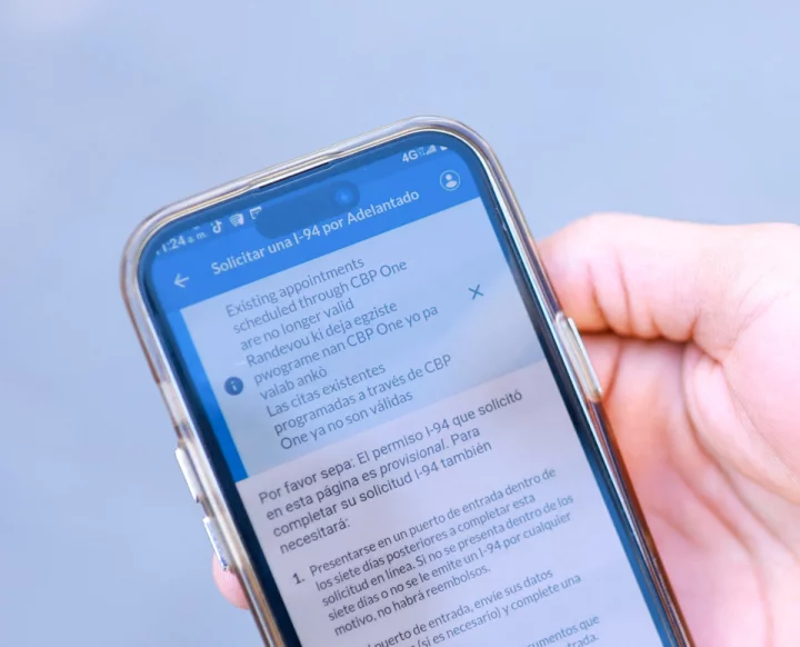 A migrant's phone displays a message stating that appointments scheduled through the CBP One app are no longer valid.