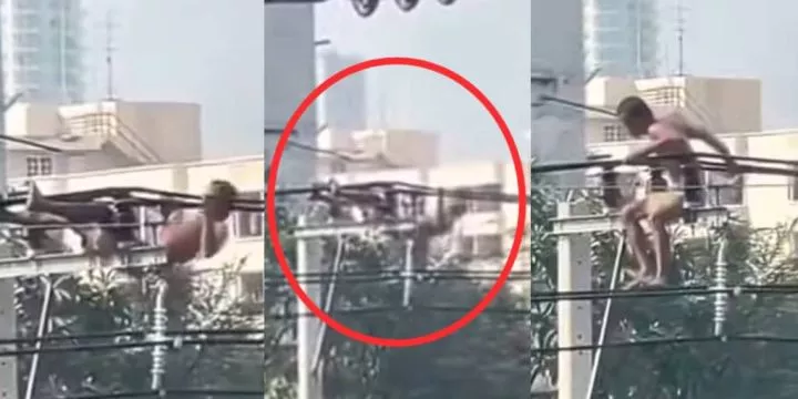 Man performs push-ups on a power line