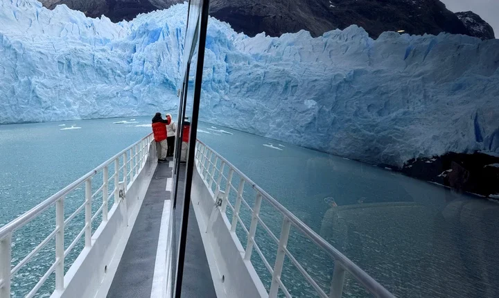The Perito Moreno glacier is seen reflected in the window of a tourist boat, near the city of El Calafate in the Patagonian province of Santa Cruz, Argentina April 22, 2025. REUTERS/Bernat Parera