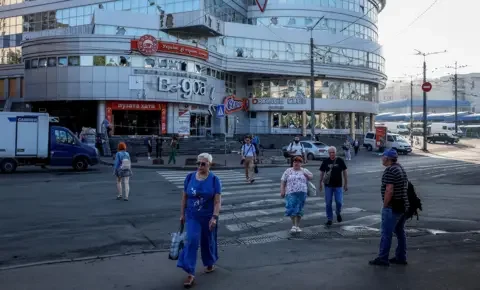 Reuters People walk across a zebra crossing outside a shopping mall in Kyiv on Thursday.