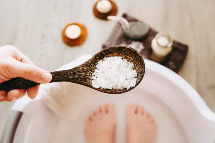 woman soaking feet in epsom salt soak