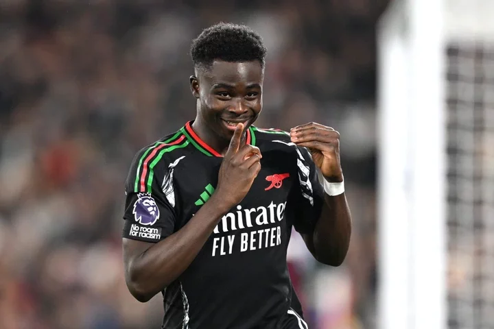 Bukayo Saka of Arsenal celebrates scoring his team's fifth goal from a penalty kick during the Premier League match between West Ham United FC and ...