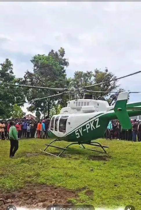 Shocking moment as man hangs onto helicopter mid-air