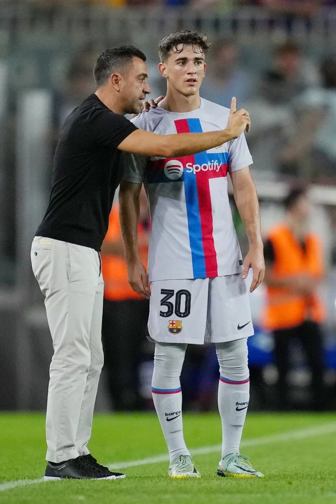 BARCELONA, SPAIN - AUGUST 24: Xavi, Head coach of FC Barcelona speaks to Gavi of FC Barcelona during the friendly match between FC Barcelona and Manchester City at Camp Nou on August 24, 2022 in Barcelona, Spain. (Photo by Alex Caparros/Getty Images)