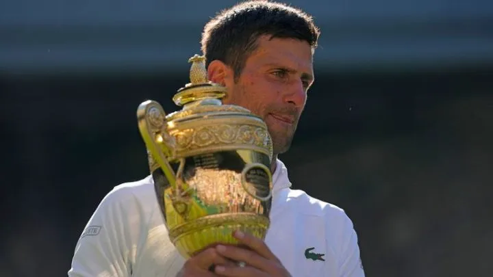 Novak Djokovic holds the Wimbledon singles trophy after beating Nick Kyrgios in the 2022 final. Pic: AP