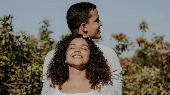 smiling couple outside back to back