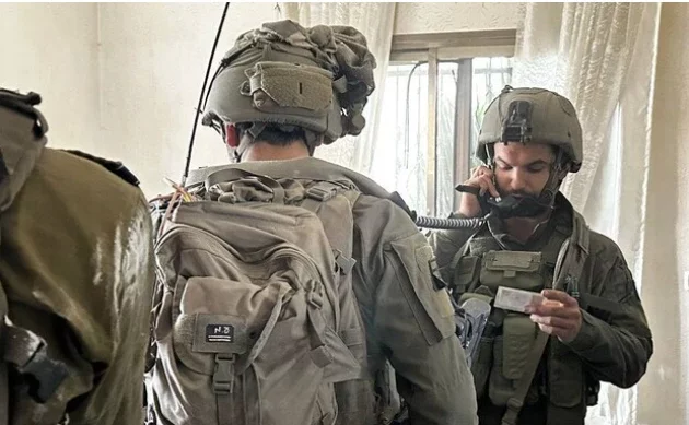 IDF soldiers stare at the ID of the infamous terror boss
