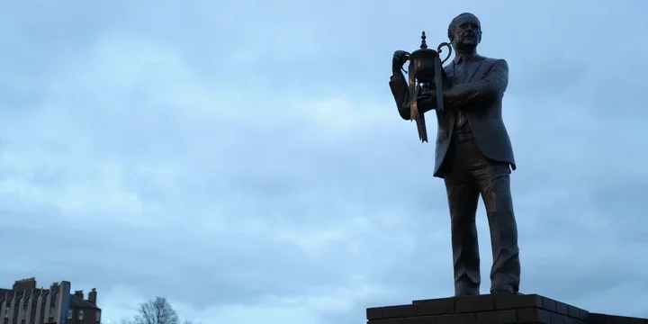 Jim McLean statue holding trophy 