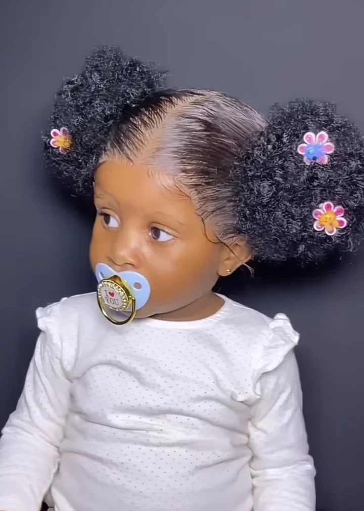 'Let babies be babies' - Netizens react as mother installs frontal wig for her daughter for first birthday