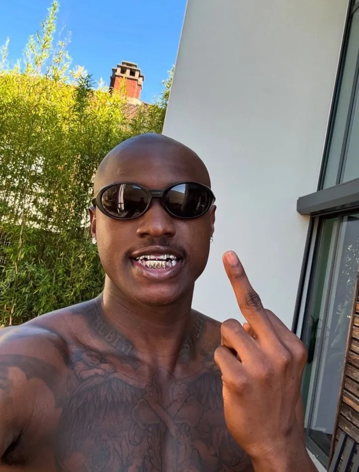 Singer Ruger Dumps Signature Pink Hair, Shows Off Tattoos in Paris