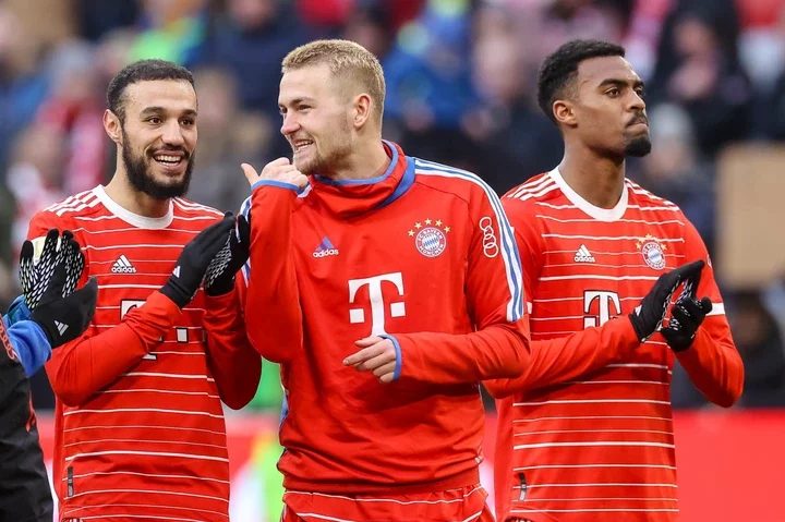 Noussair Mazraoui of Bayern Muenchen, Matthijs de Ligt of Bayern Muenchen and Ryan Gravenberch of Bayern Muenchen look on prior to the Bundesliga m...