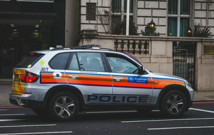 Police Car Passing by Road