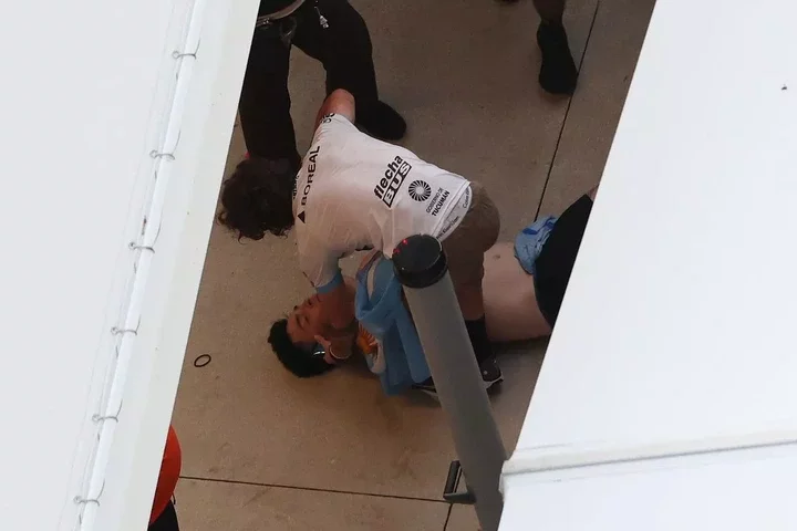 A fan of Argentina is injured and appears passed out on the floor