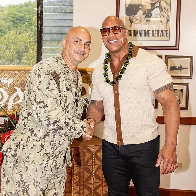 The final image showed him shaking hands with a serviceman while wearing a green lei for the outing