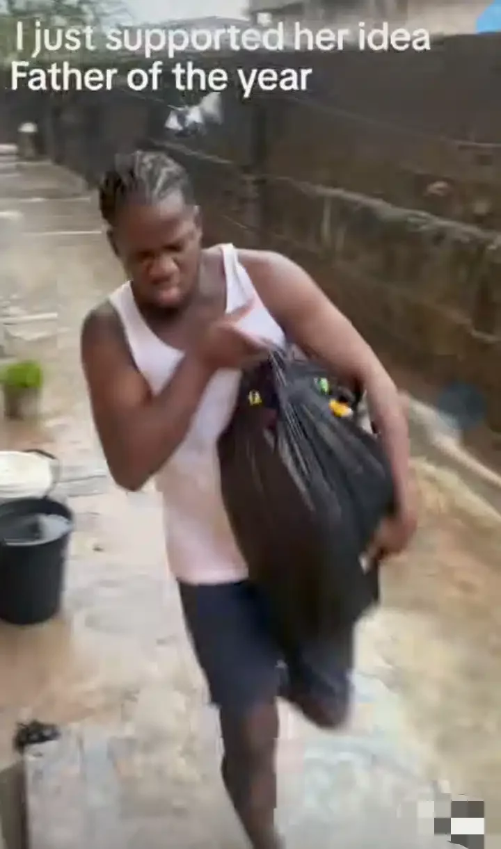 'You for explain tire if police catch you' - Man carries little daughter in nylon bag to protect her from rain