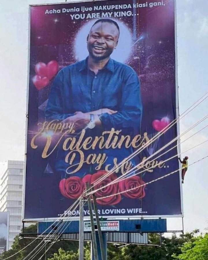 Lady wows her husband as she puts up his picture on a billboard