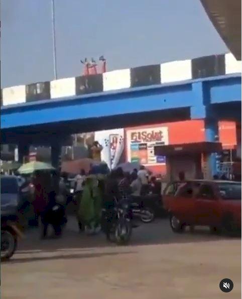 Three men on red wrapper caught on camera taking their bath on a bridge in Ibadan (Video)