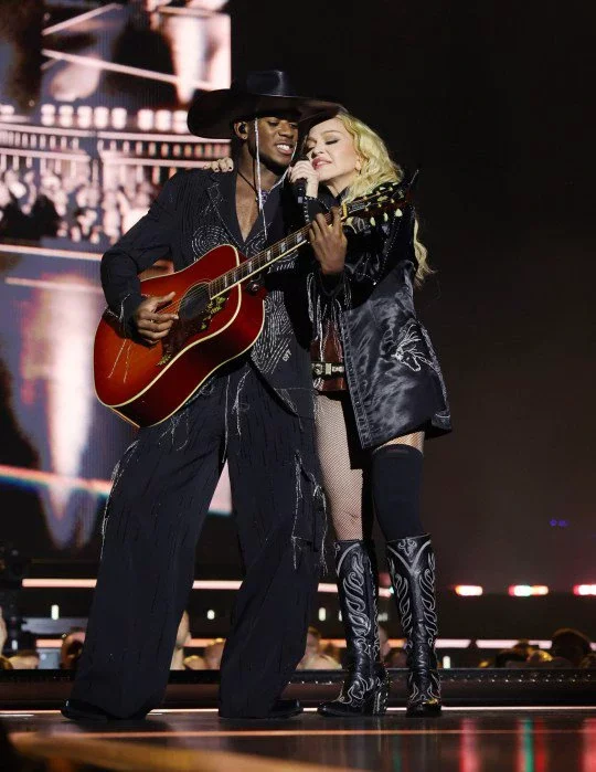 Madonna and David Banda singing on stage