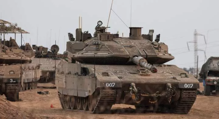 An Israeli tank and military vehicles near Israel's border with the Gaza Strip in southern Israel [Reuters]