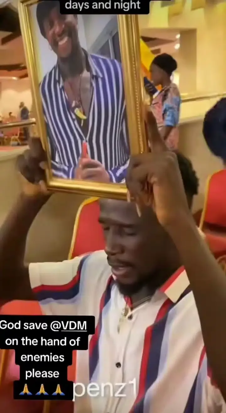 Man takes Verydarkman's photo to night vigil for prayers