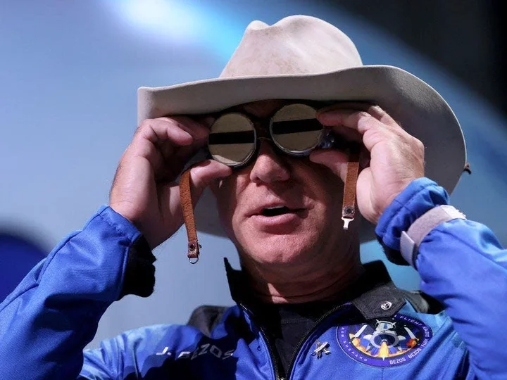 photo of Jeff Bezos wearing Blue Origin jumpsuit and cowboy hat