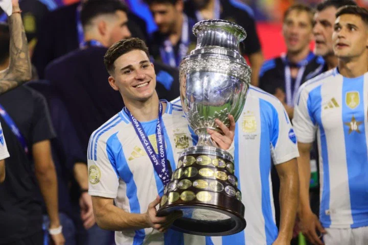 Jul 14, 2024; Miami, FL, USA; Argentina forward Julian Alvarez (9) with the trophy after the Copa America final against Colombia at Hard Rock Stadium. Mandatory Credit: Sam Navarro-USA TODAY Sports